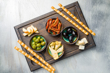 antipasti on wooden board on grey table top view