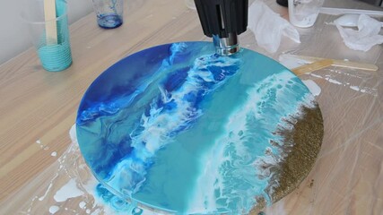 Epoxy resin art. Imitation of the sea. Sea foam. Modern trendy hobby. Macro photo. Pouring process