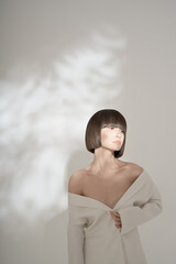 Beautiful brunette with graphic bob haircut wear white fashion jacket - 482434387
