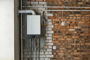New white big and long pipes, electical cords and outlets imbuilt in brick textured white and red wall of building