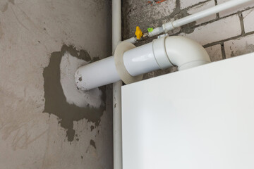 New white big pipe in wall of building