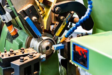 Close up workpiece and cutting tool during production process at precision automation turning...