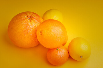 citrus on a yellow background. Orange, tangerine, grapefruit on a yellow background