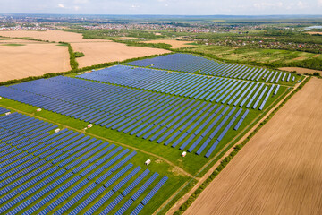 Aerial view of big sustainable electric power plant with many rows of solar photovoltaic panels for producing clean ecological electrical energy. Renewable electricity with zero emission concept