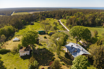 Aerial view of coutryside, cottages in the woods. Hiiu, Estonia. - obrazy, fototapety, plakaty
