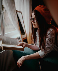 a girl with dark long hair in a red beret and a white blouse, retro style. Indoor soft light