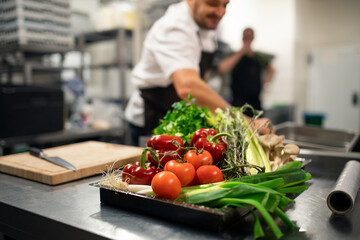 Fresh ripe vegetables prepared for cutting in commercial kitchen.