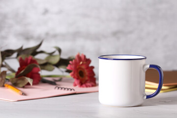 a mug of tea is on the desktop in the office