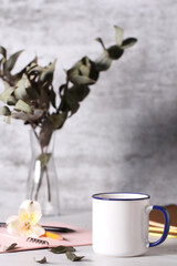 a mug of tea is on the desktop in the office