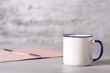 a mug of tea is on the desktop in the office