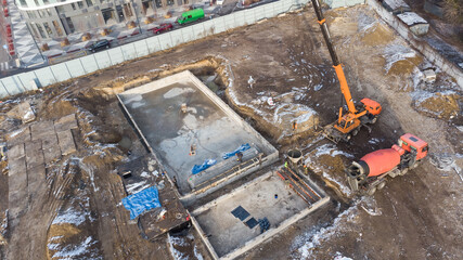 Drones aerial photo of a construction site of a pool, formwork concrete blocks already finished and bricked up with construction adhesive, steps already prepared and ready for concrete filling.