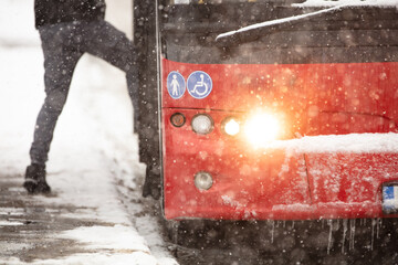 Bus public transportation on snowy streets in winter conditions.