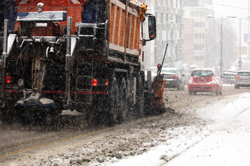 Snow plow truck cleaning streets from heavy snowfall.