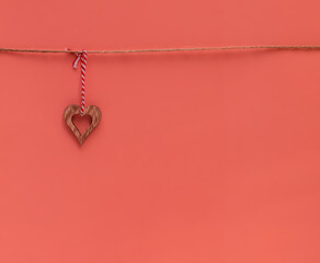 Wooden hearts on a rope on a red background. Composition for Valentine's Day. Flat lay, copy space. Greeting card. 