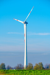 Windmills wind turbines farm power generators. Production of renewable green energy