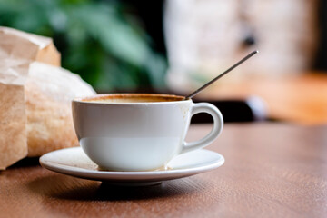 Cup of coffee latte on in a cafe on a wooden table