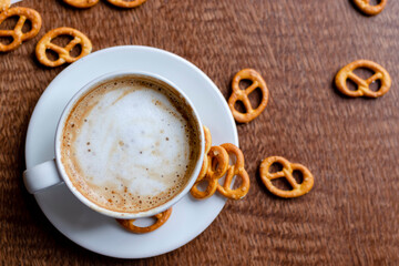 Cup of coffee latte on in a cafe on a wooden table