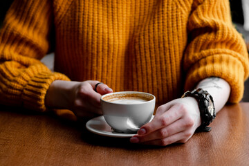 Woman in a cafe drinking coffee