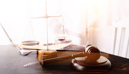 Business and lawyers discussing contract papers with brass scale on desk in office. Law, legal services, advice, justice and law concept picture with film grain effect