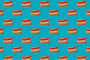 Pattern Bread croutons with pickled chili on a blue background