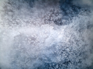 Top view of snowy conifer crowns. Nature pattern. Drone shot.