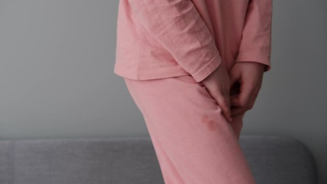 Woman Holding Wet Pants Can`t Control Her Pee because of Stress