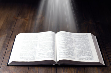 Fototapeta premium Open Bible. Open book. Light from a book. Old antique book. Magic, fairy tale.