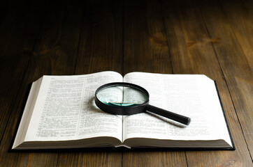 Open Bible. On the table. Holy Bible, Scripture. Magnifier	
