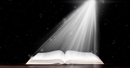 Bible. Open book. Light from a book. Old antique book. Magic, fairy tale.