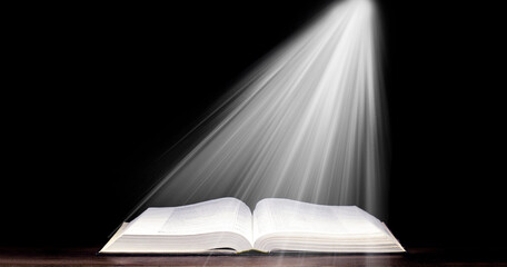 Bible. Open book. Light from a book. Old antique book. Magic, fairy tale.