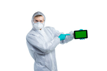 Fototapeta na wymiar A scientist in special protective clothing carefully looks at us and points to the tablet. Bacteria, viruses, toxic, caustic substances, coronavirus epidemic, flu. isolated
