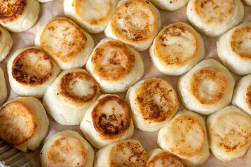 Cheesecakes on a baking sheet, cook in the dining room. Beautiful, rosy and fried.