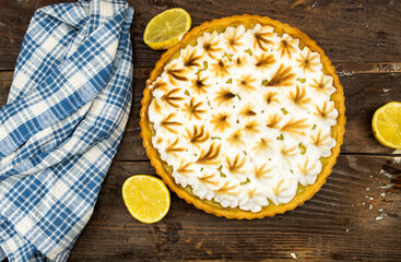 homemade lemon meringue pie with lemon fruit on  wooden background