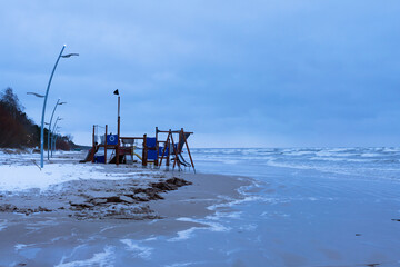 Fototapeta na wymiar Children ground in winter stormy sea beach