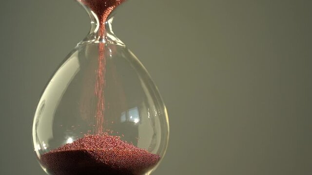 Hourglass measuring the passing time in a countdown to a deadline