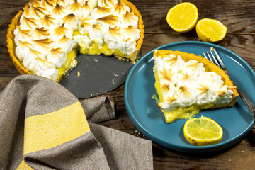 homemade lemon meringue pie with lemon fruit on  wooden background