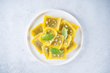 Fresh prepared Ravioli pasta with mushrooms and cheese in a plate