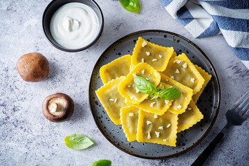 Fresh prepared Ravioli pasta with mushrooms and cheese in a plate