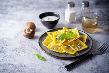 Fresh prepared Ravioli pasta with mushrooms and cheese in a plate