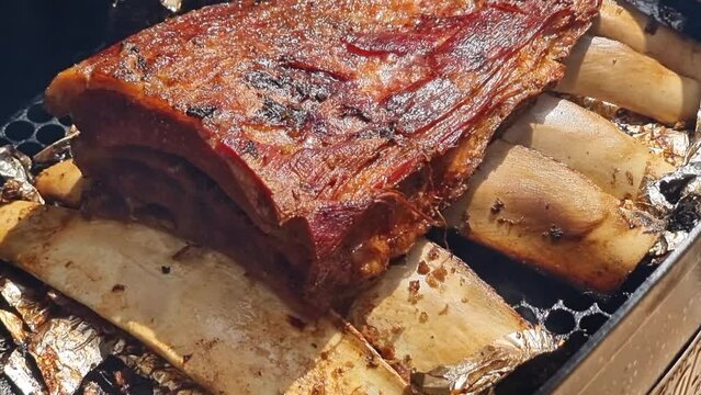 Brazilian beef ribs roasted and smoked on the barbecue grill, seasoned with coarse salt.