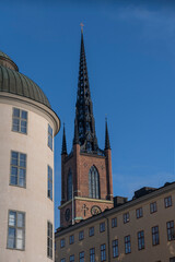 Fototapeta na wymiar Facades of court houses and the tower of the church Riddarholmskyrkan a sunny winter day in Stockholm