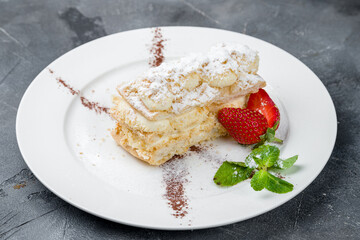 Napoleon dessert on plate on grey table