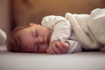 Cute little baby sleeping in cradle at home