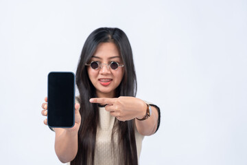 woman pointing finger at smartphone on white background focus on smartphone