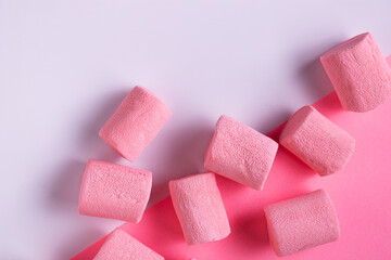 pink marshmallow lies on white paper, close-up