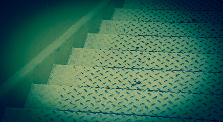 Steel diamond plate stairs and concrete wall. Abstract sad background. Depression concept