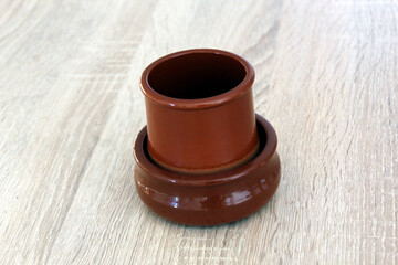 Romanian traditional two ceramic pots from Horezu isolated on wood background