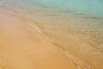 Fototapeta na wymiar Waves on the tropical sandy beach of the red sea.