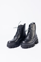 Women's black leather boots on a white background. Shoes and options for its layout. Autumn shoes. Boots. Autumn boots. Shoes close up