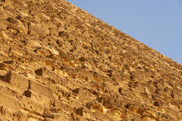 Fototapeta na wymiar The pyramid of Cheops with a blue sky in the background.